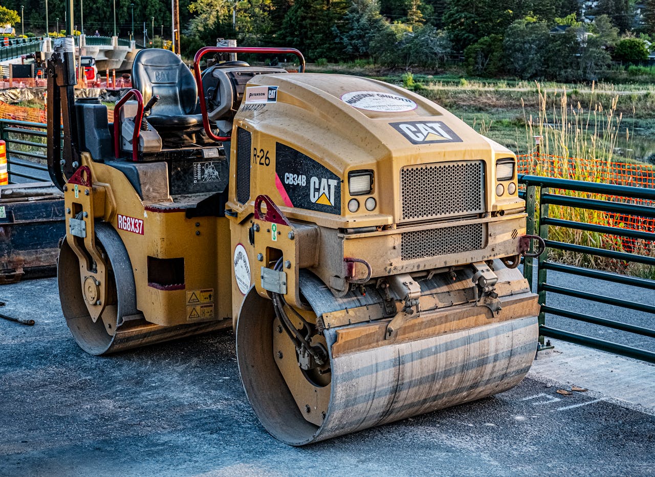 A CAT road roller on an outdoor construction site, perfect for industrial imagery.